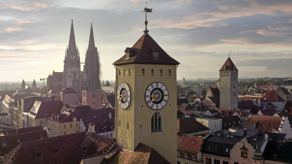 Blick über die historische Altstadt von Regensburg mit Uhrturm und Kathedrale, ideal für Kultur- und Städtereisen.
